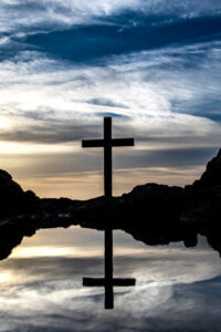 A cross near a lake as a reminder of Jesus' love and sacrifice for the world