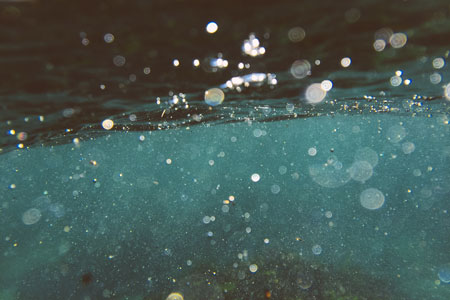 A close-up with water and droplets symbolizing baptism