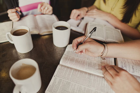 A group of girls drinking coffee and reading their Bibles