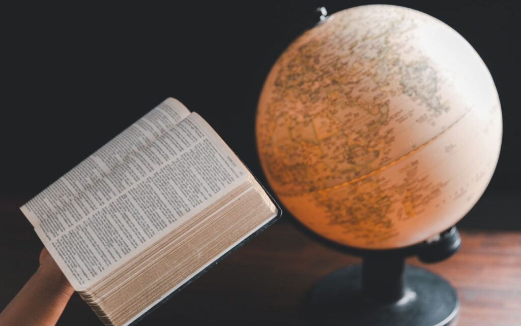 A Bible and a globe depicting the two "books" Christians can use to uncover God's truth.