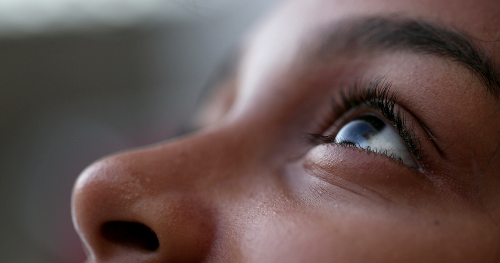 A closeup of a woman's eye as she looks upward.