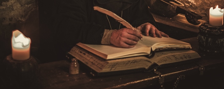 A scribe in a dimly lit room, writing about Jesus, reflecting efforts to preserve proof that Jesus existed.