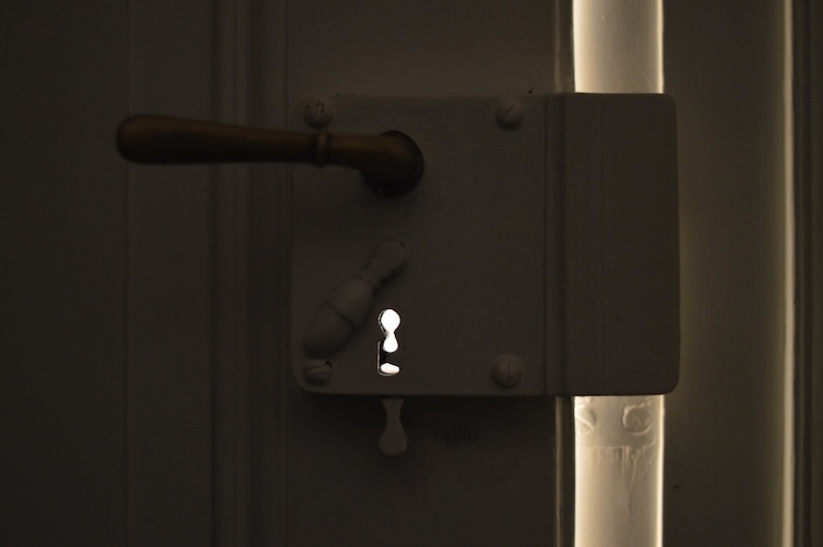 Light shines through a small keyhole, symbolizing hope.