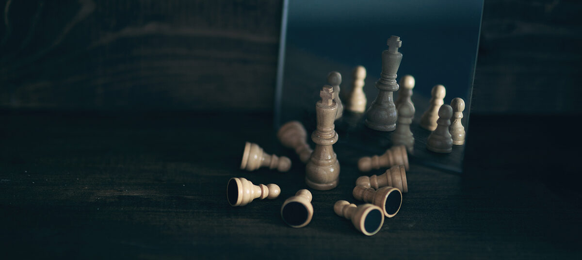 Chess pieces arranged on a board representing thoughtful discussion about biblical contradictions.