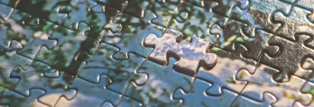 Puzzle pieces fitting together, symbolizing efforts to understand and resolve biblical contradictions.