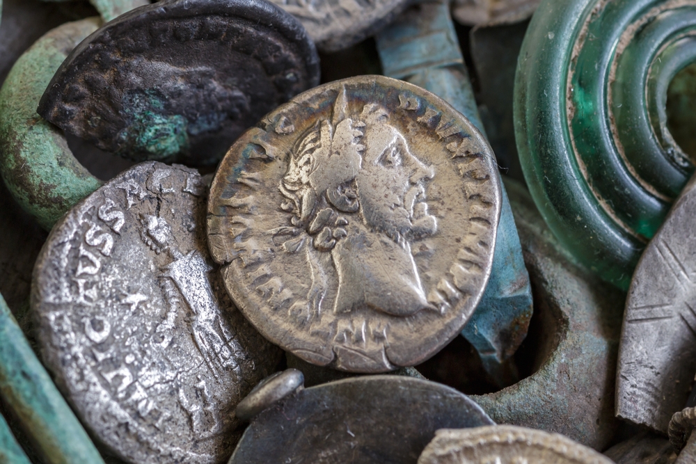 Ancient coins and artifacts illustrating historical links between religion and political authority often discussed in debates about Christian nationalism.