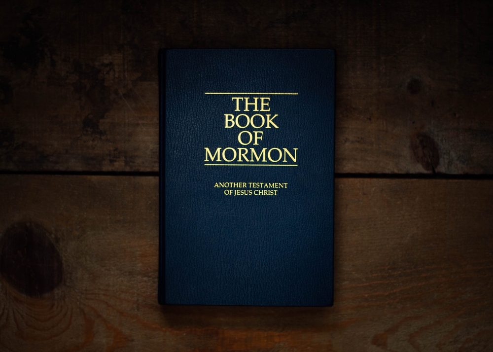 The Book of Mormon resting on a table, representing core Mormon beliefs and teachings.