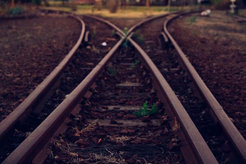 Railroad tracks splitting into two directions at a junction.