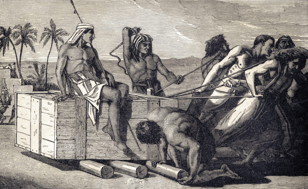 Historical engraving of enslaved Hebrews forced to pull a load in Egypt, an image related to the Bible and slavery.