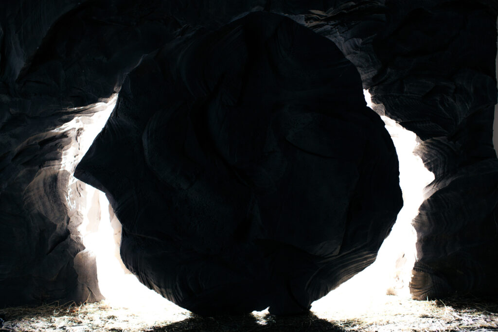 Empty tomb with the stone rolled away symbolizing life after death.