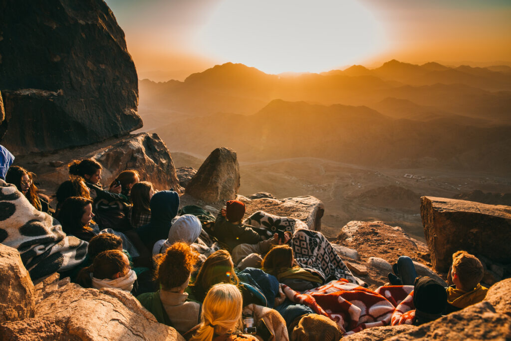 People gathered on a hillside symbolizing the setting of biblical miracles.