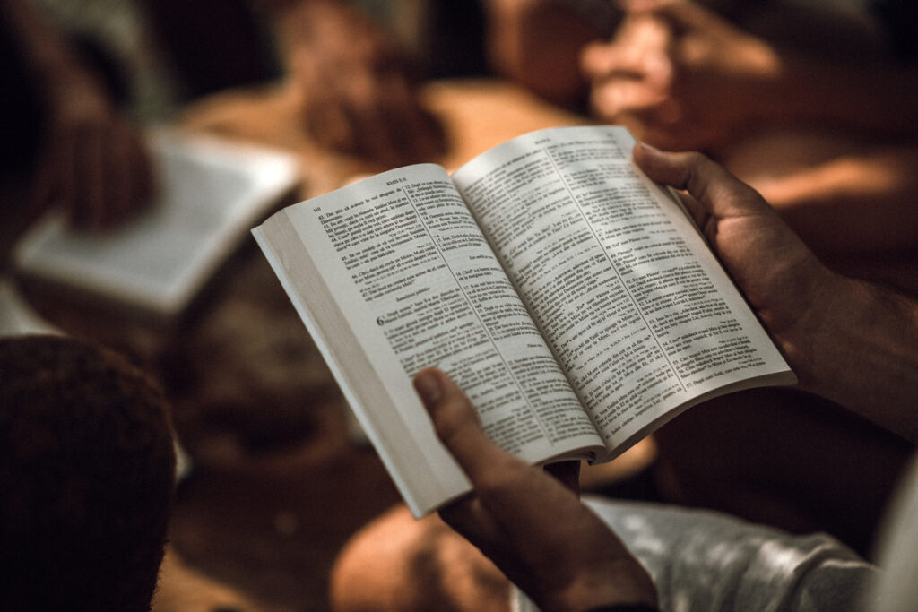 Person reading an open Bible, reflecting thoughtful study behind the question “is the Bible true.”