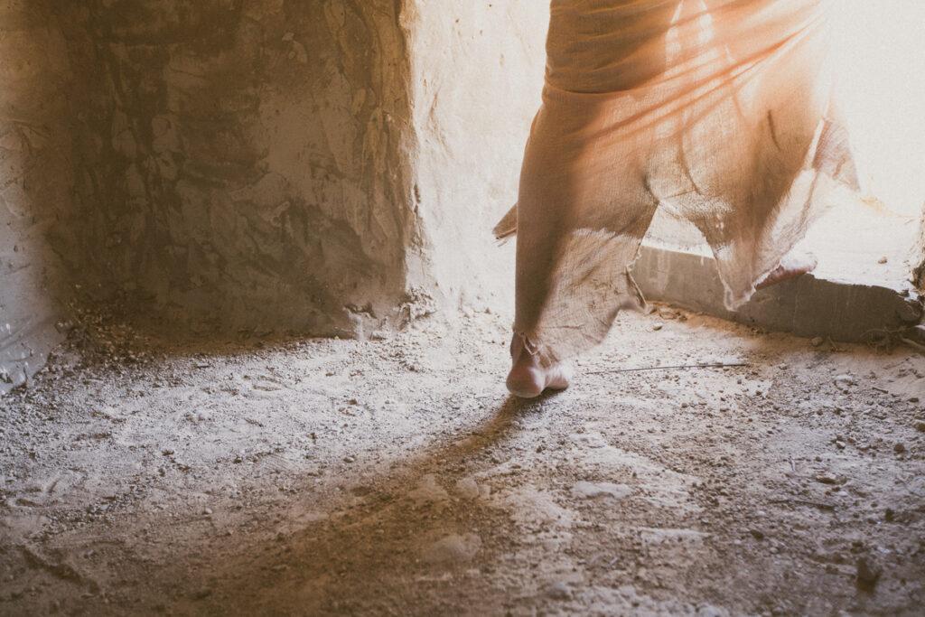 Person stepping into light from darkness, symbolizing the transformative power often associated with miracles.