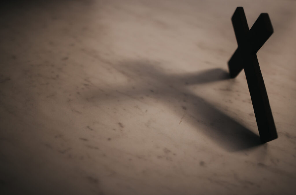 A closeup of a small cross on a table