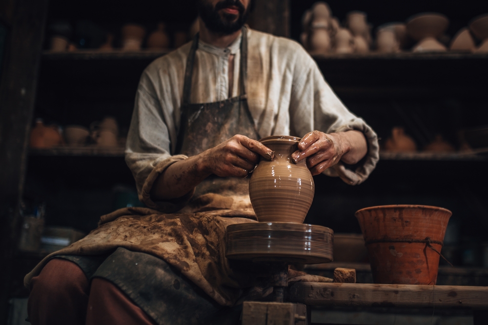 A potter creating a new jar to symbolize God creating Adam and Eve