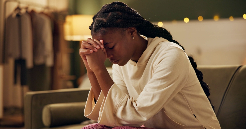 Woman praying with folded hands, reflecting faith and hope for miracles.