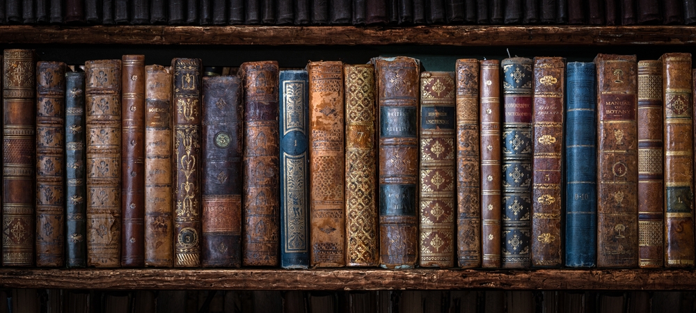 Old library books symbolizing scholarly investigation into the question “is the Bible true.”